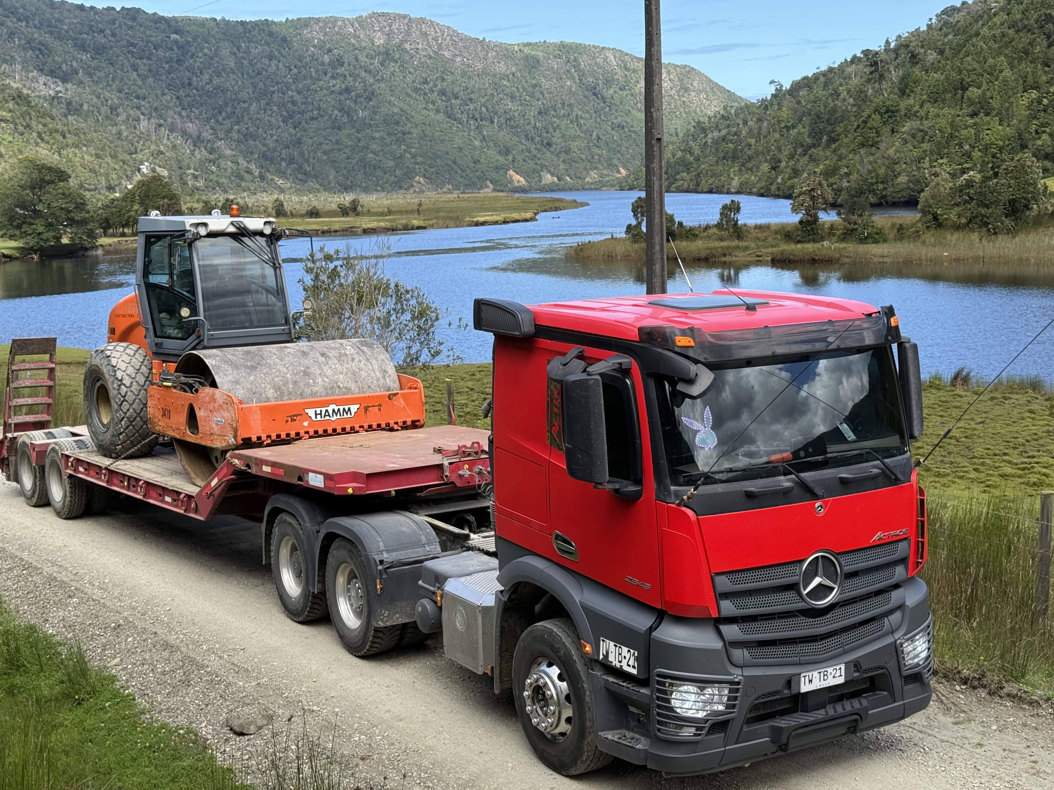 Camión cama baja de Transportes Flores trasladando rodillo compactador